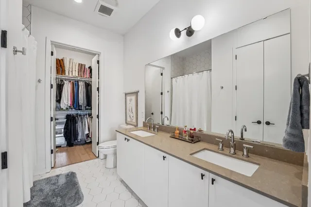 a bathroom with a double vanity sink and a mirror