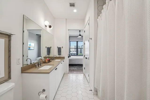 a bathroom with a double vanity sink and mirror