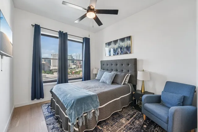 a bedroom with a bed couch and a window