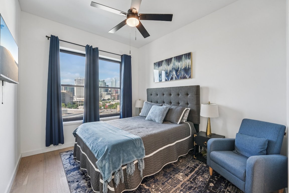 800 Embassy Drive, Unit 429 Austin, TX 78702 - Photo 19 of 40 a bedroom with a bed couch and a window