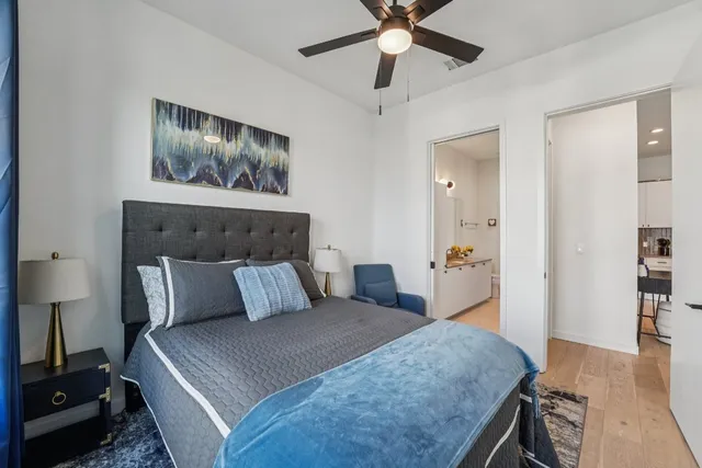 a bedroom with a bed and a chandelier