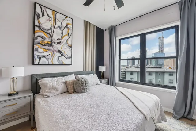 a bedroom with a large bed and a large window