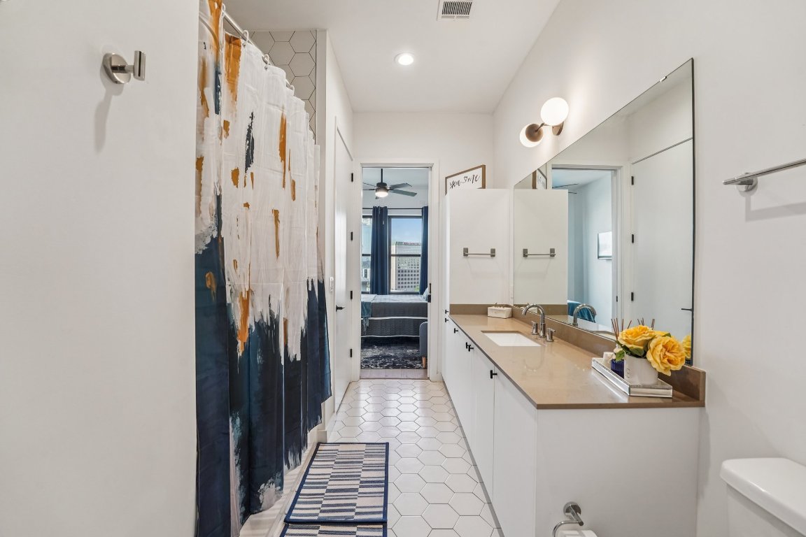 800 Embassy Drive, Unit 429 Austin, TX 78702 - Photo 5 of 40 a kitchen with stainless steel appliances granite countertop a refrigerator and a stove
