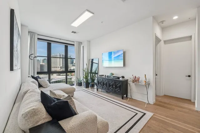 a living room with furniture and wooden floor