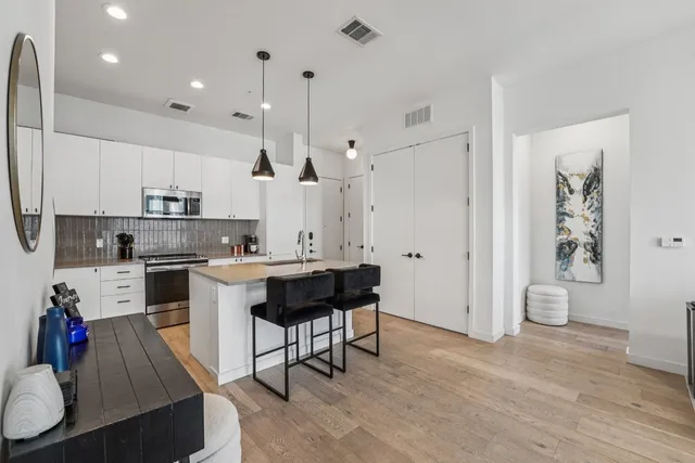 a kitchen with a sink appliances and cabinets