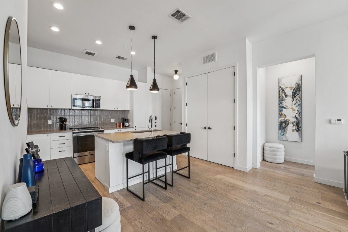 800 Embassy Drive, Unit 429 Austin, TX 78702 - Photo 9 of 40 a kitchen with a sink appliances and cabinets