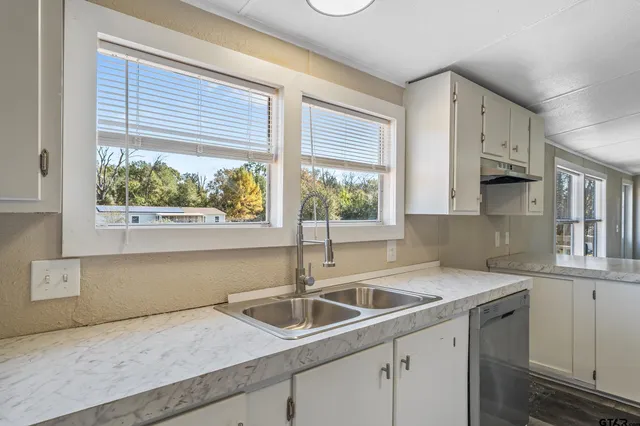 a kitchen with a sink and large window
