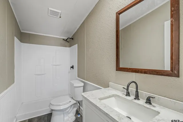 a bathroom with a sink toilet and shower