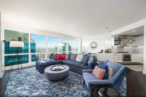 a living room with furniture a rug and a lamp
