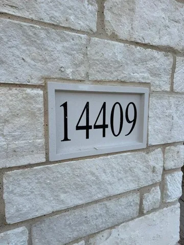 a sign that is on a brick wall