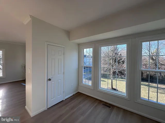 a view of an empty room with glass door and balcony