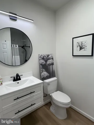 a bathroom with a toilet a sink and mirror