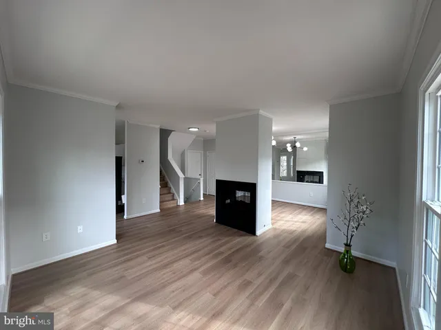 a view of a room with wooden floor