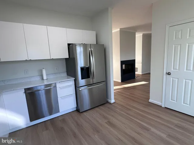 a kitchen with stainless steel appliances granite countertop a refrigerator microwave and stove