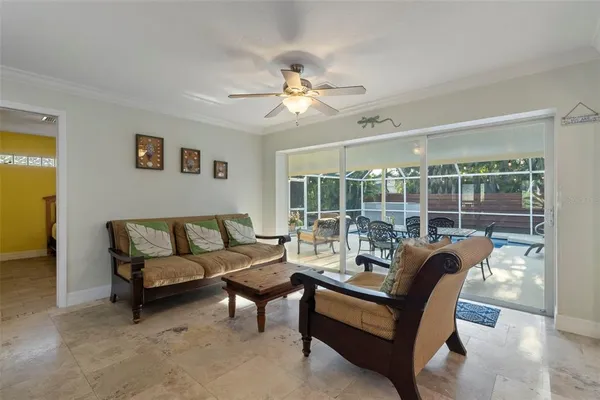 a living room with furniture and a chandelier