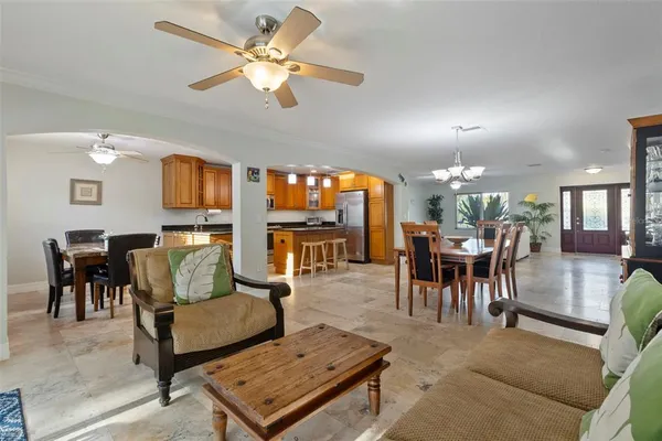 a kitchen with stainless steel appliances granite countertop wooden cabinets and a refrigerator