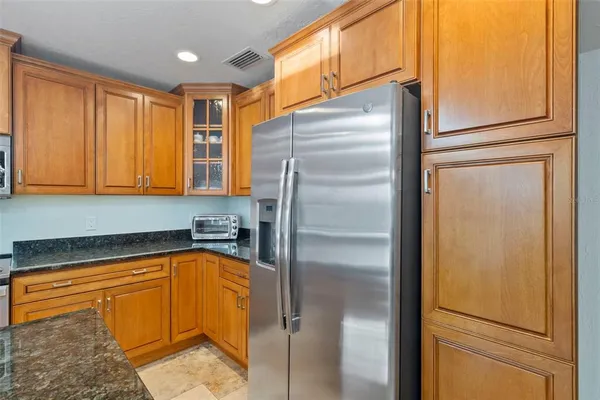 a kitchen with stainless steel appliances granite countertop a sink and cabinets