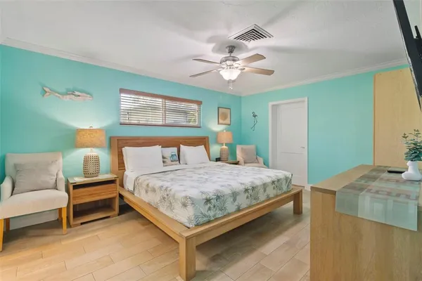 a bedroom with a bed and a chandelier