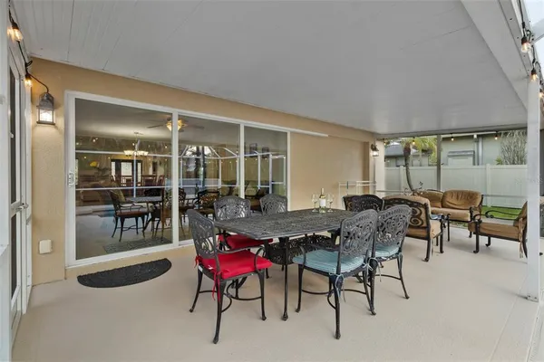 a view of a house with backyard and sitting area