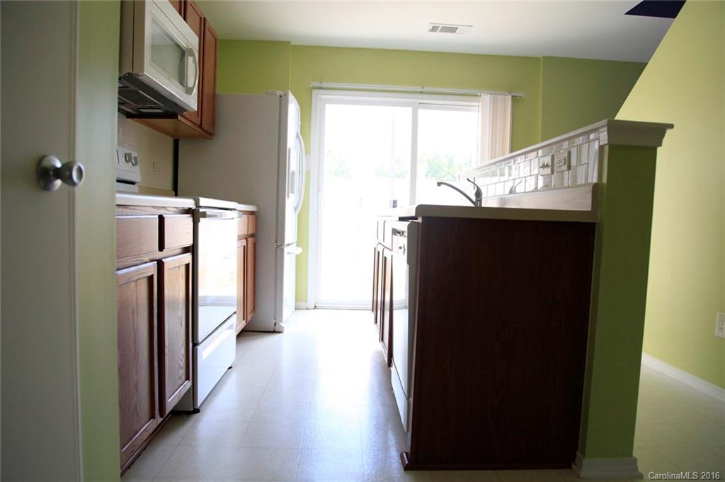 653 Potter Place Road, Unit 110 Fort Mill, SC 29708 - Photo 11 of 22 a view of hallway with stairs and wooden floor