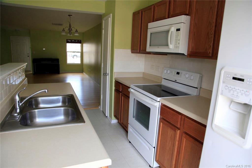 653 Potter Place Road, Unit 110 Fort Mill, SC 29708 - Photo 12 of 22 a kitchen with a sink and a stove top oven