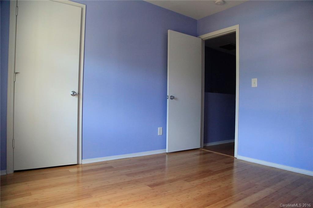 653 Potter Place Road, Unit 110 Fort Mill, SC 29708 - Photo 16 of 22 a view of an empty room with wooden floor and closet