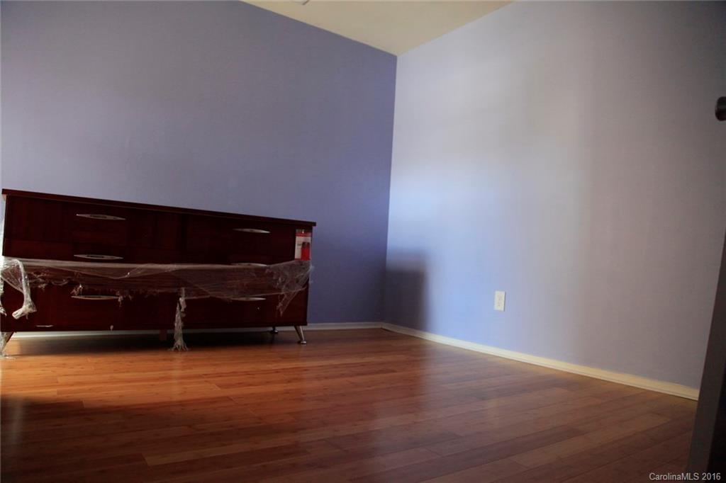 653 Potter Place Road, Unit 110 Fort Mill, SC 29708 - Photo 17 of 22 a room with wooden floor and a rug