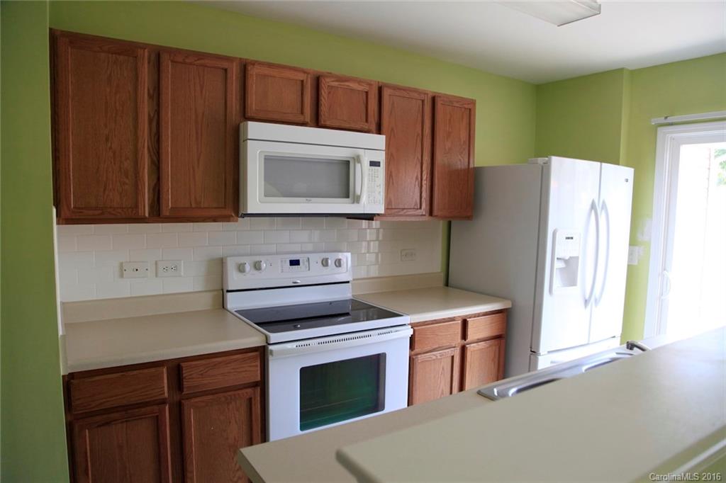 653 Potter Place Road, Unit 110 Fort Mill, SC 29708 - Photo 8 of 22 a kitchen with stainless steel appliances a stove a microwave and a refrigerator