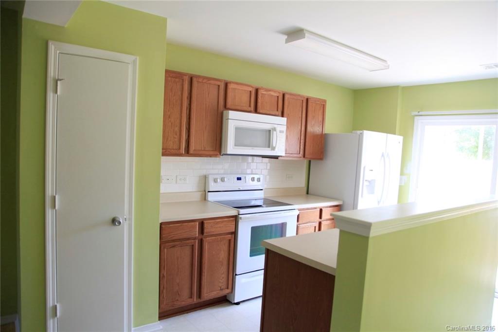653 Potter Place Road, Unit 110 Fort Mill, SC 29708 - Photo 9 of 22 a kitchen with stainless steel appliances a stove refrigerator sink and microwave