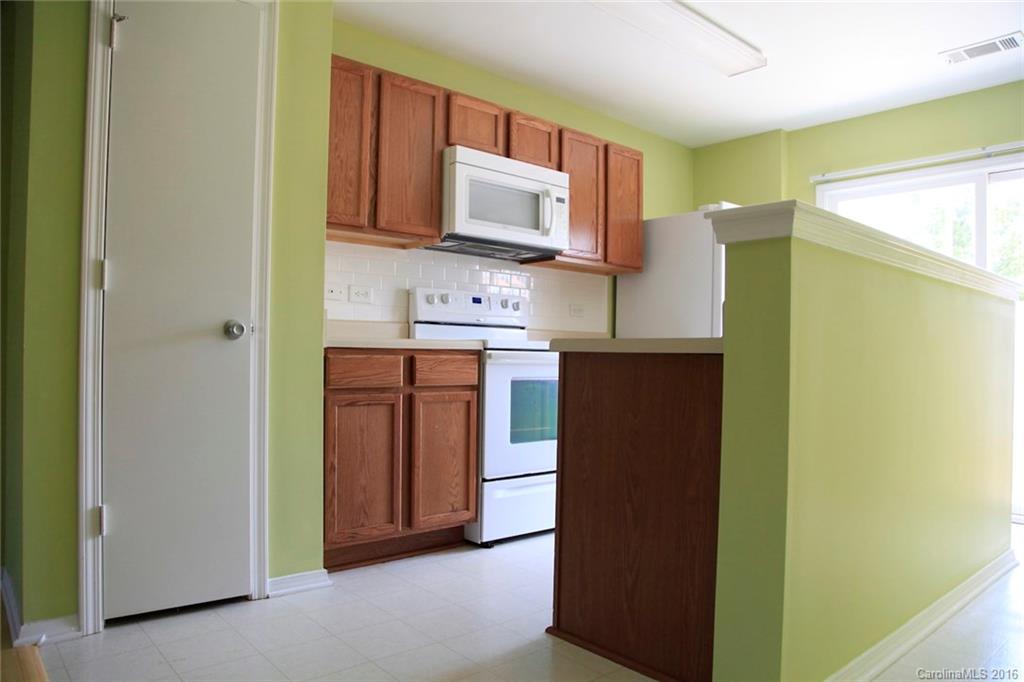 653 Potter Place Road, Unit 110 Fort Mill, SC 29708 - Photo 10 of 22 a kitchen with stainless steel appliances granite countertop a refrigerator and a stove top oven