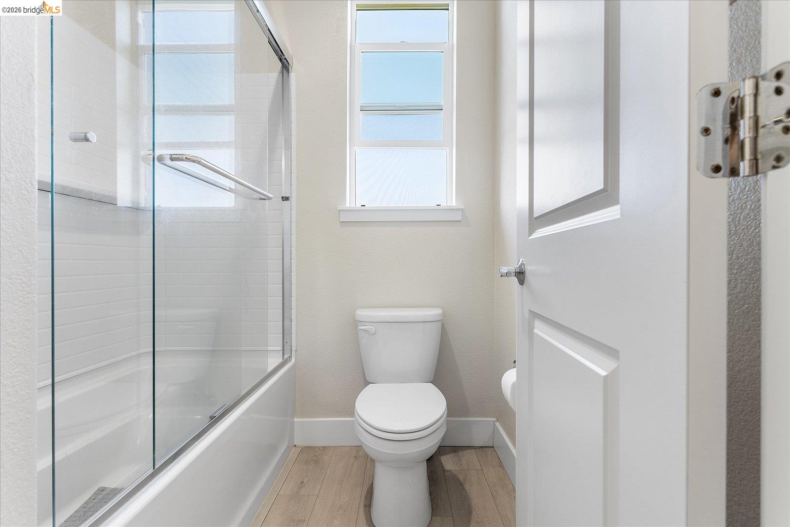 5601 Ridgepoint Way Antioch, CA 94531 - Photo 32 of 59 Bathroom featuring a tub/shower combination with glass enclosure, white subway tile surround, and a window