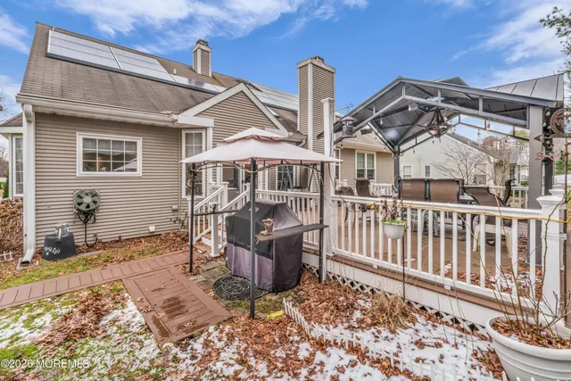 a wooden bench sitting in front of a house