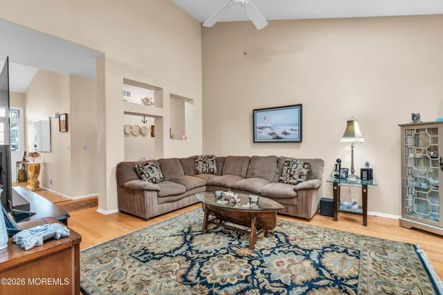 a living room with furniture and wooden floor