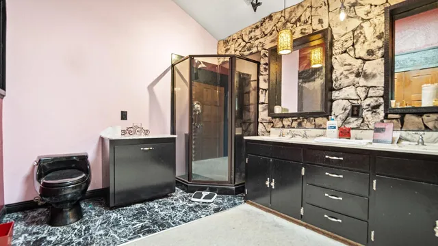 a bathroom with a sink toilet and shower