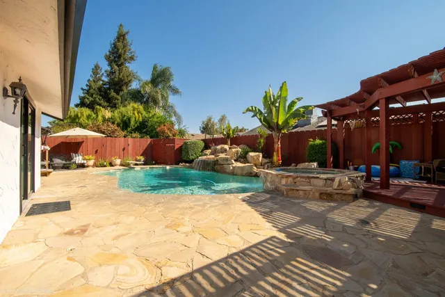 a view of a backyard with sitting area