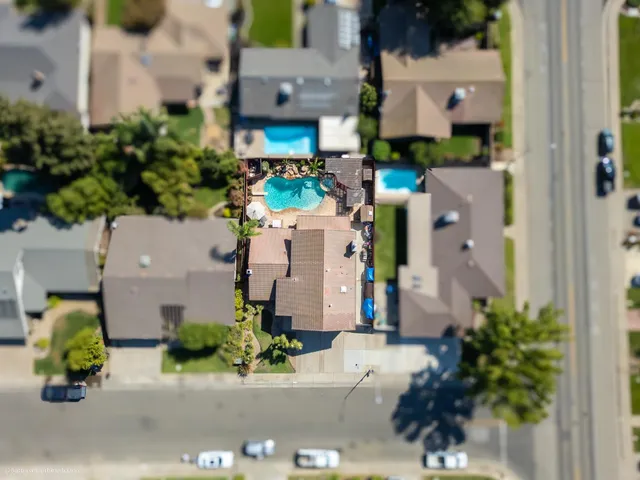 an aerial view of a house with a street