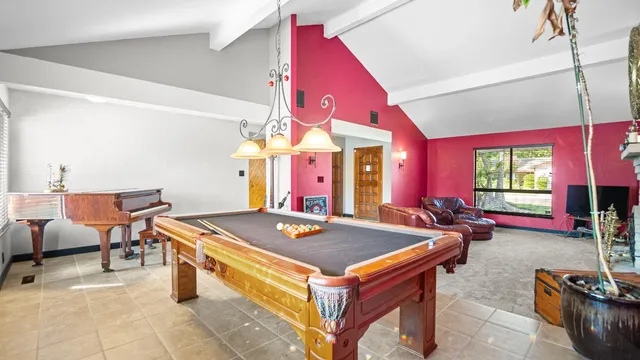 a room with furniture pool table and flat screen tv