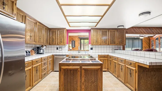a kitchen with a sink stove and cabinets