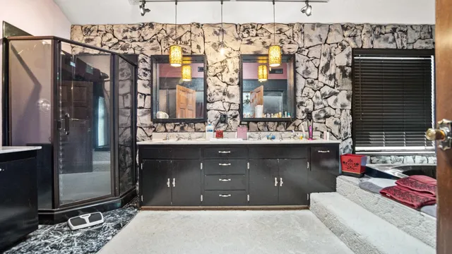 a bathroom with a sink vanity and a mirror
