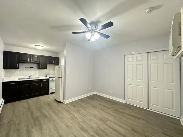 a large kitchen with stainless steel appliances granite countertop a stove a sink and a refrigerator