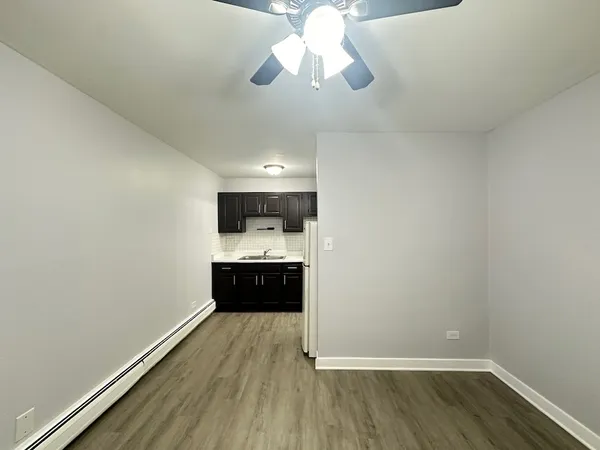 a kitchen with a refrigerator and a stove top oven