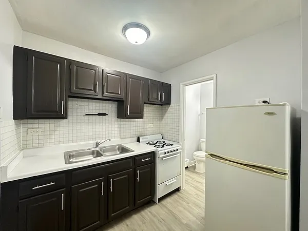 a kitchen with stainless steel appliances a refrigerator sink and cabinets