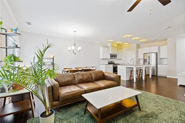 a living room with furniture and wooden floor
