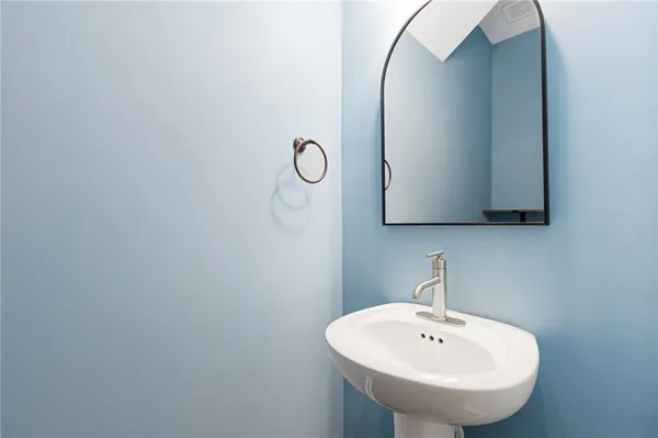 a bathroom with a sink and mirror