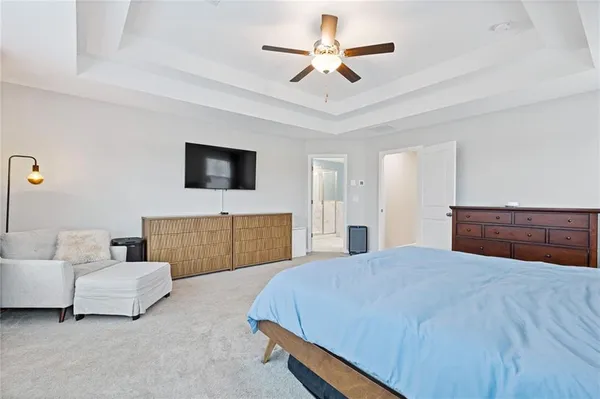 a spacious bedroom with a bed and a couch