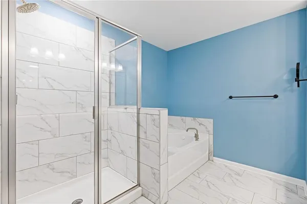 a bathroom with a bathtub and shower