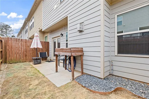 a view of a patio with a table and chairs