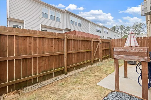 a view of a balcony with wooden floor and fence