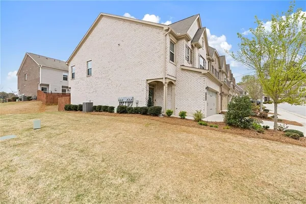 a view of a white house with a yard