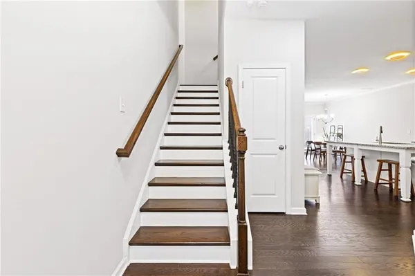 a view of entryway and hall with wooden floor